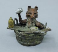 A cold painted bronze model of a fox in a bath. 5.5 cm high.