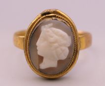 An 18 ct gold cameo ring. Cameo 1.5 cm high. Ring size S/T. 3.7 grammes total weight.