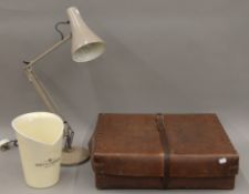 A vintage laundry box, an anglepoise lamp and a champagne bucket.