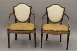 A pair of Georgian mahogany framed open arm chairs. 59 cm wide.