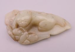A jade model of a dog-of-fo and butterfly on a leaf. 11 cm long.