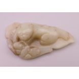 A jade model of a dog-of-fo and butterfly on a leaf. 11 cm long.
