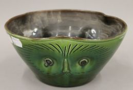 A Watcombe pottery bowl formed as owl masks. 20 cm diameter.