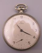 An Omega pocket watch. Approximately 5 cm diameter.