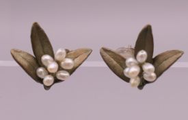 A pair of Michael Levin mistletoe form earrings. 2 cm high.