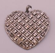 A diamond heart shaped pendant. 4.25 cm wide, 4 cm high.