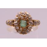 An 18 ct gold, diamond and emerald ring. Ring size O/P. 4.3 grammes total weight.