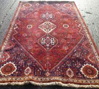 A red ground wool rug. 175 x 290 cm.