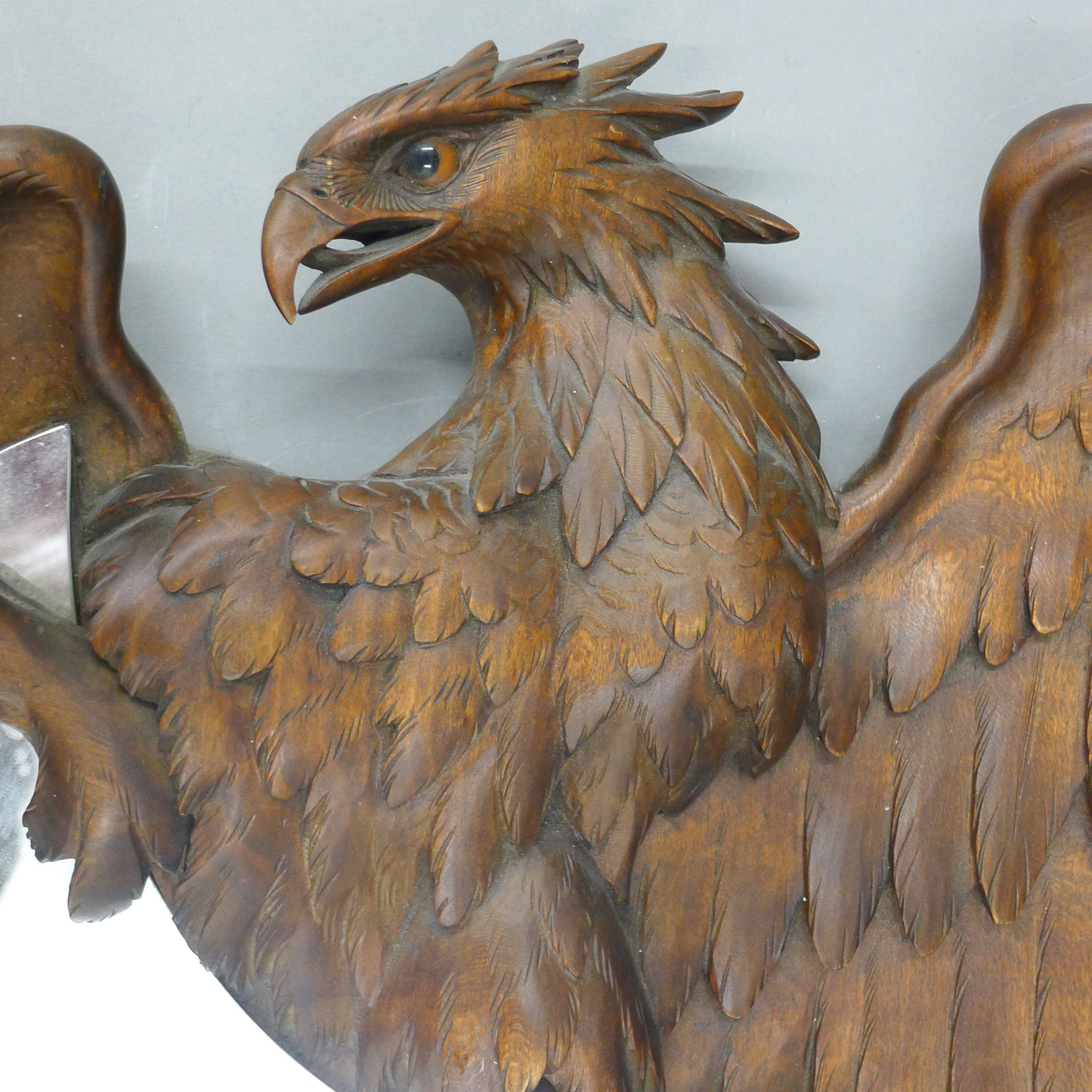 A 19th century Blackforest carved wooden mirror formed as a bird of prey. 43.5 cm high. - Image 3 of 3