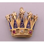 An unmarked gold, diamond, ruby and enamel crown form pendant. 2.25 cm wide x 2 cm high.