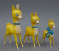 Three Babycham deer and a Babycham deer plaque. The largest 19 cm high.