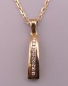A diamond and 9 ct gold pendant on 9 ct gold chain. Pendant 1.