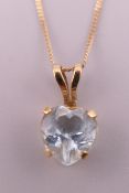 A 10 ct gold aquamarine heart shaped pendant on a 9 ct gold chain.