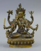 A gilt bronze model of a deity decorated with coral and turquoise. 21.5 cm high.