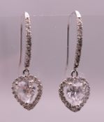 A pair of 9 ct white gold heart shaped drop earrings. 2.5 cm high. 1.9 grammes total weight.