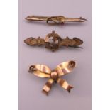 Three 9 ct gold brooches. Bow form brooch 3.5 cm wide. 6 grammes total weight.