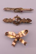 Three 9 ct gold brooches. Bow form brooch 3.5 cm wide. 6 grammes total weight.