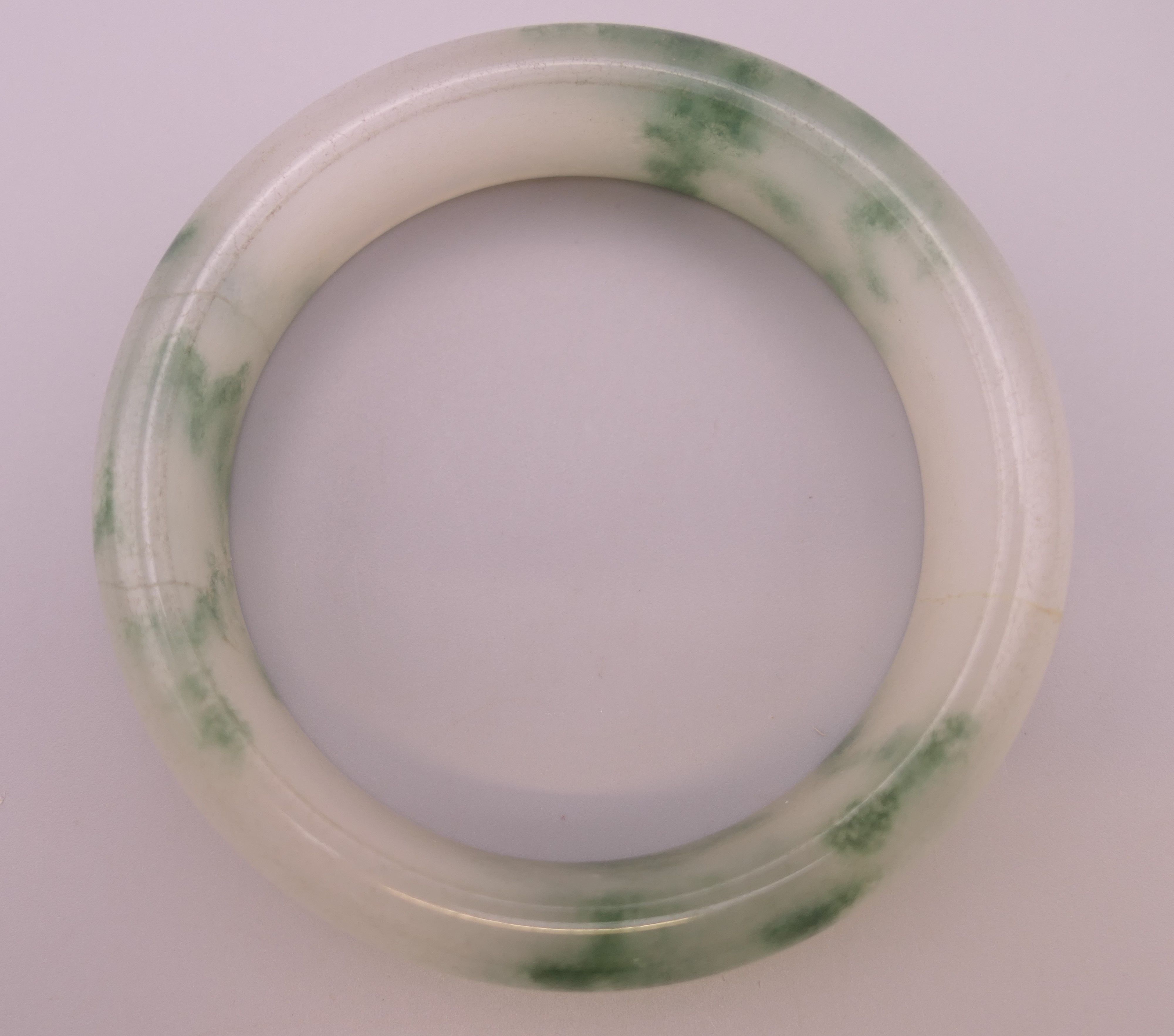 A jade bangle. Internal diameter 5.75 cm. - Image 3 of 3