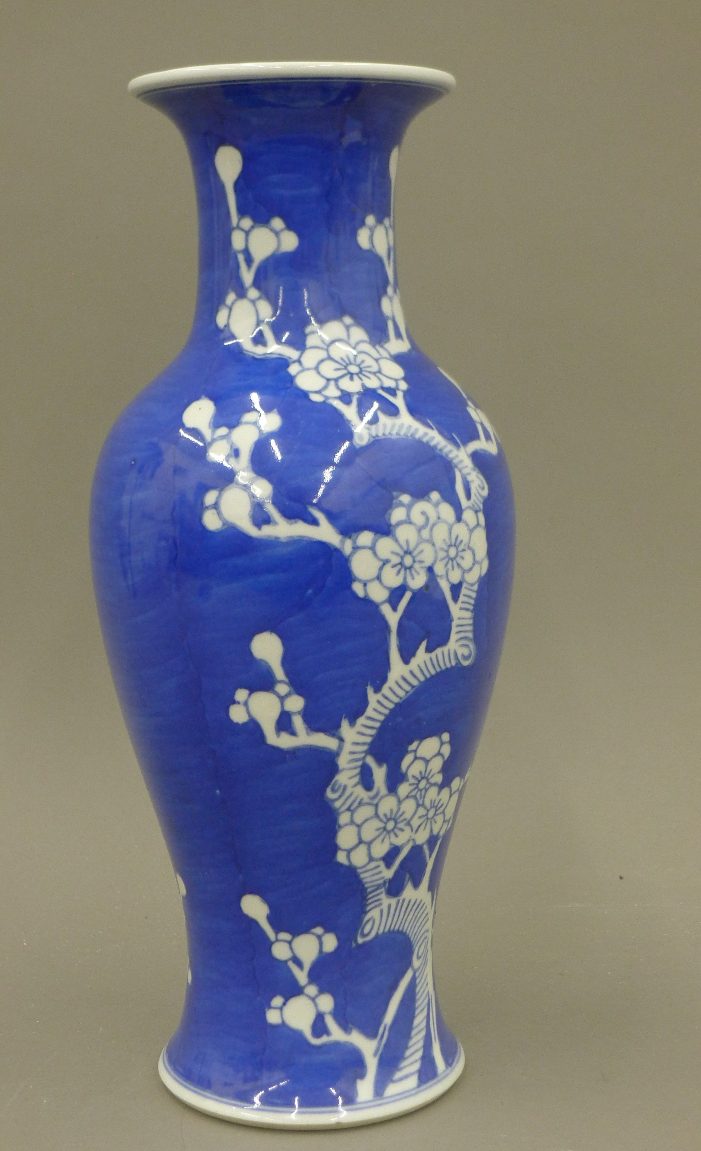 A Chinese blue and white porcelain vase decorated with prunus blossom, with character mark to base.