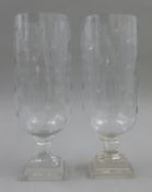 A pair of cut glass storm lamps. Each approximately 40 cm high.