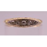 An 18 ct gold five stone diamond ring. Ring size N/O. 2.6 grammes total weight.