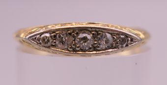 An 18 ct gold five stone diamond ring. Ring size N/O. 2.6 grammes total weight.