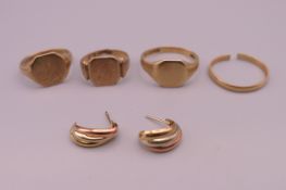 Three 9 ct gold rings and a pair of 9 ct gold earrings (10.