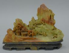 A Chinese stone boulder carving of a mountainous landscape. 17.5 cm long.