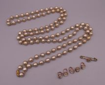 A faux pearl necklace and a quantity of various shirt studs. The necklace 148 cm long.