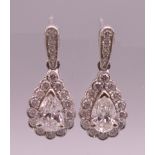 A pair of 18 ct white gold pear shaped earrings. Approximately 1 carat total diamond weight.