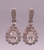 A pair of 18 ct white gold pear shaped earrings. Approximately 1 carat total diamond weight.