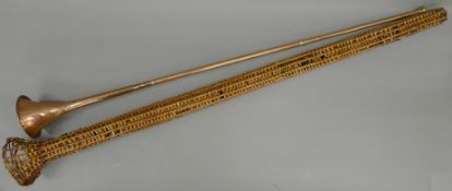 A mail coach copper horn London to Dover, with wicker case. 127 cm long.