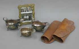 Three silver plated sauce boats, a pair of leather gaiters and a brass picture frame.