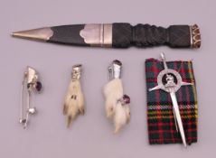 A silver mounted sgian dubh and a quantity of Scottish brooches. Sgian dubh 20.5 cm long.