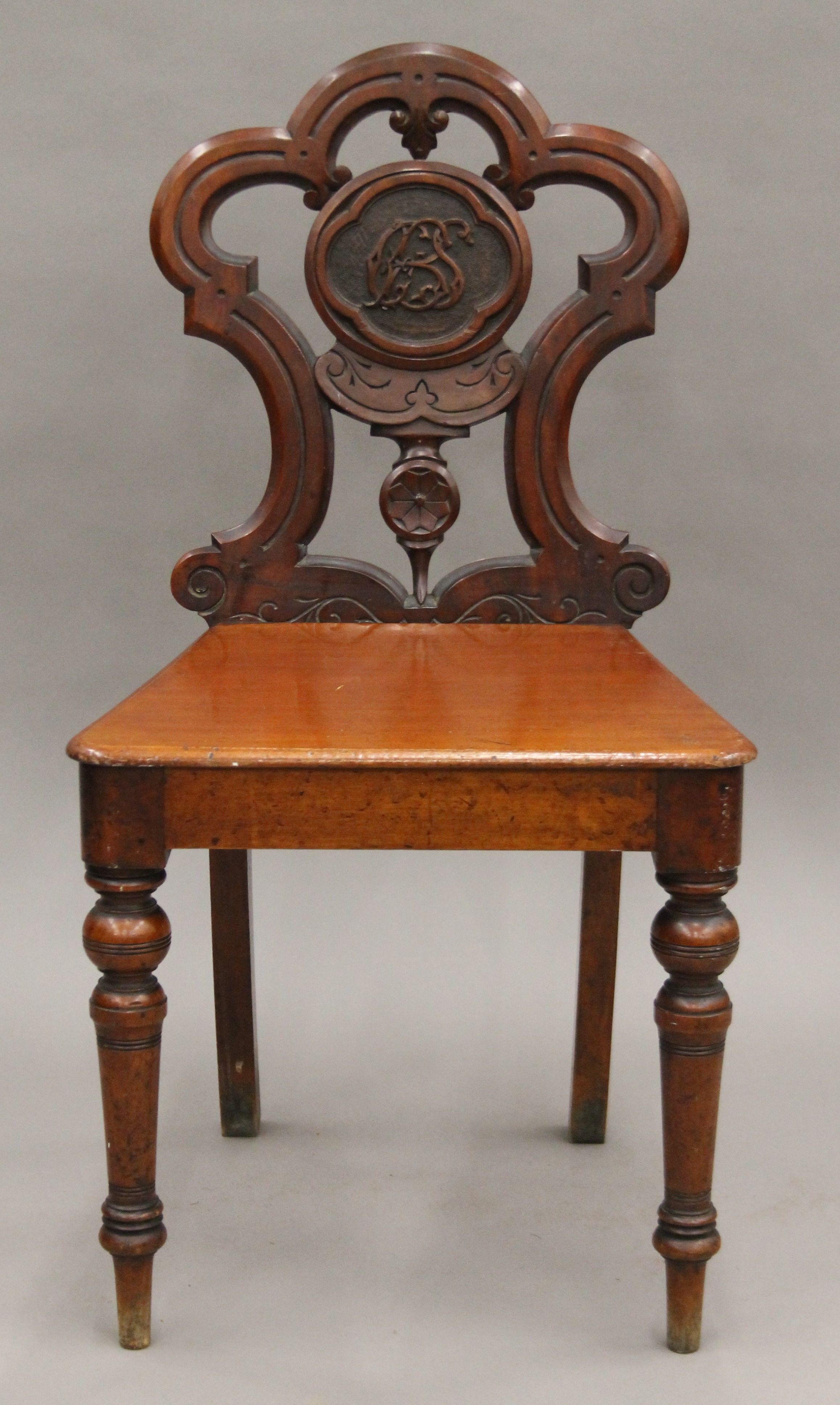 A Victorian mahogany hall chair. 46 cm wide.