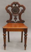 A Victorian mahogany hall chair. 46 cm wide.