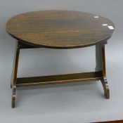 An elm drop-leaf coffee table.