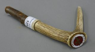 A WAGBI enamel badge, mounted on an antler walking stick handle.