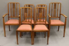 A set of six early 20th century oak dining chairs, including two with arms.