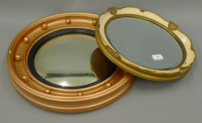 Two circular wall mirrors. The largest 46 cm diameter.