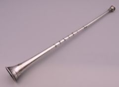 A silver horn. 30 cm long.