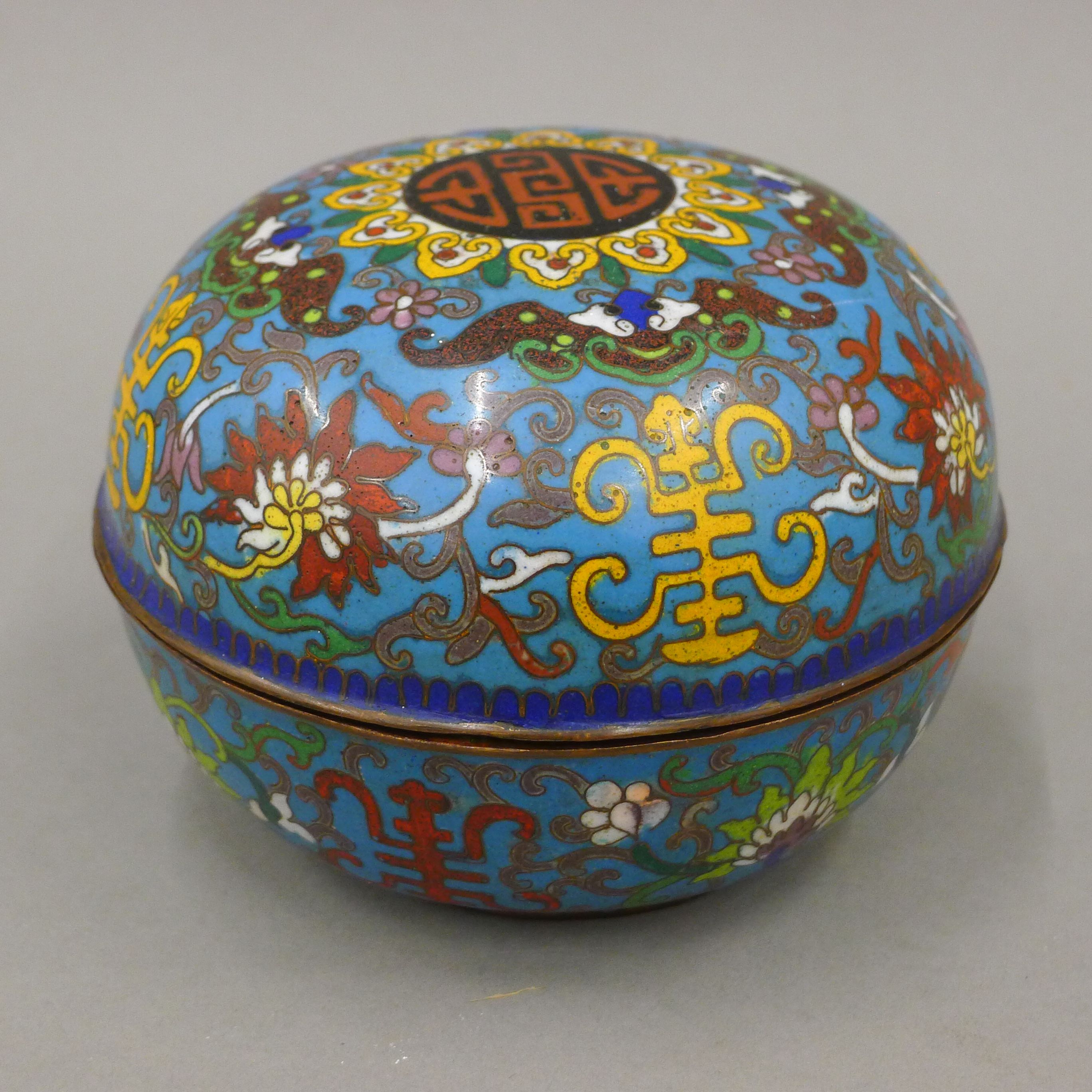 A 19th century Chinese blue ground bun shaped cloisonne box and cover, decorated with symbols,