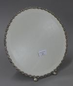 A Continental silver framed strutt mirror. 30.5 cm diameter.