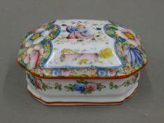 A Chinese famille rose dome top box, painted with a boy and flowers. 9.5 cm wide.