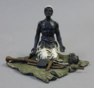 A cold painted bronze model of an Arab with guns. 10 cm high.