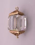 A 9 ct gold and crystal lantern design charm. 2.5 cm high. 8.2 grammes total weight.
