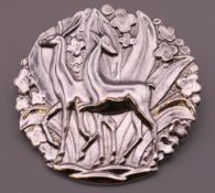 A silver deer form brooch. 4 cm diameter.