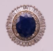 A silver, sapphire and cubic zirconia ring. Ring size Q.