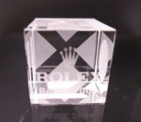 A Rolex square glass paperweight. 5 cm x 5 cm.