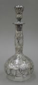An Art Nouveau decanter with silver overlay. 25 cm high.